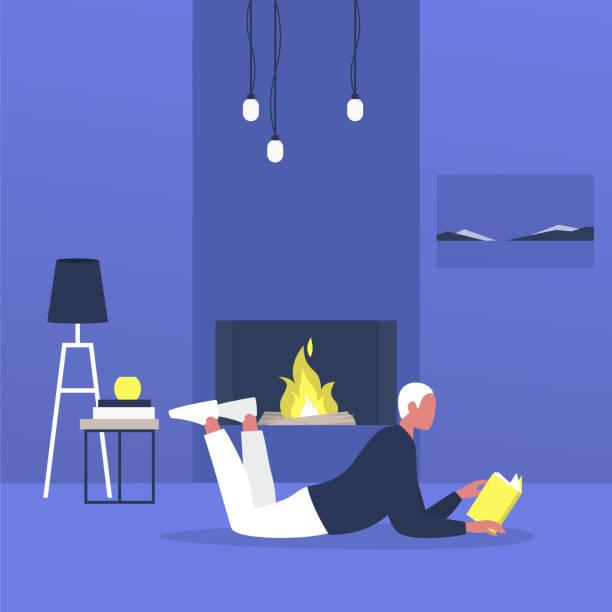 Person laying in front of fireplace reading